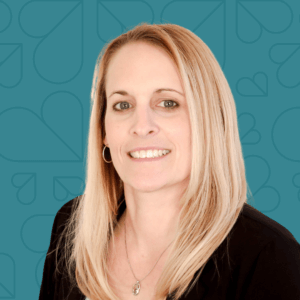Headshot of Bonnie Wrightman on a dark teal background.