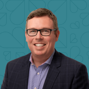 Headshot of Jeff Taylor on a dark teal background.