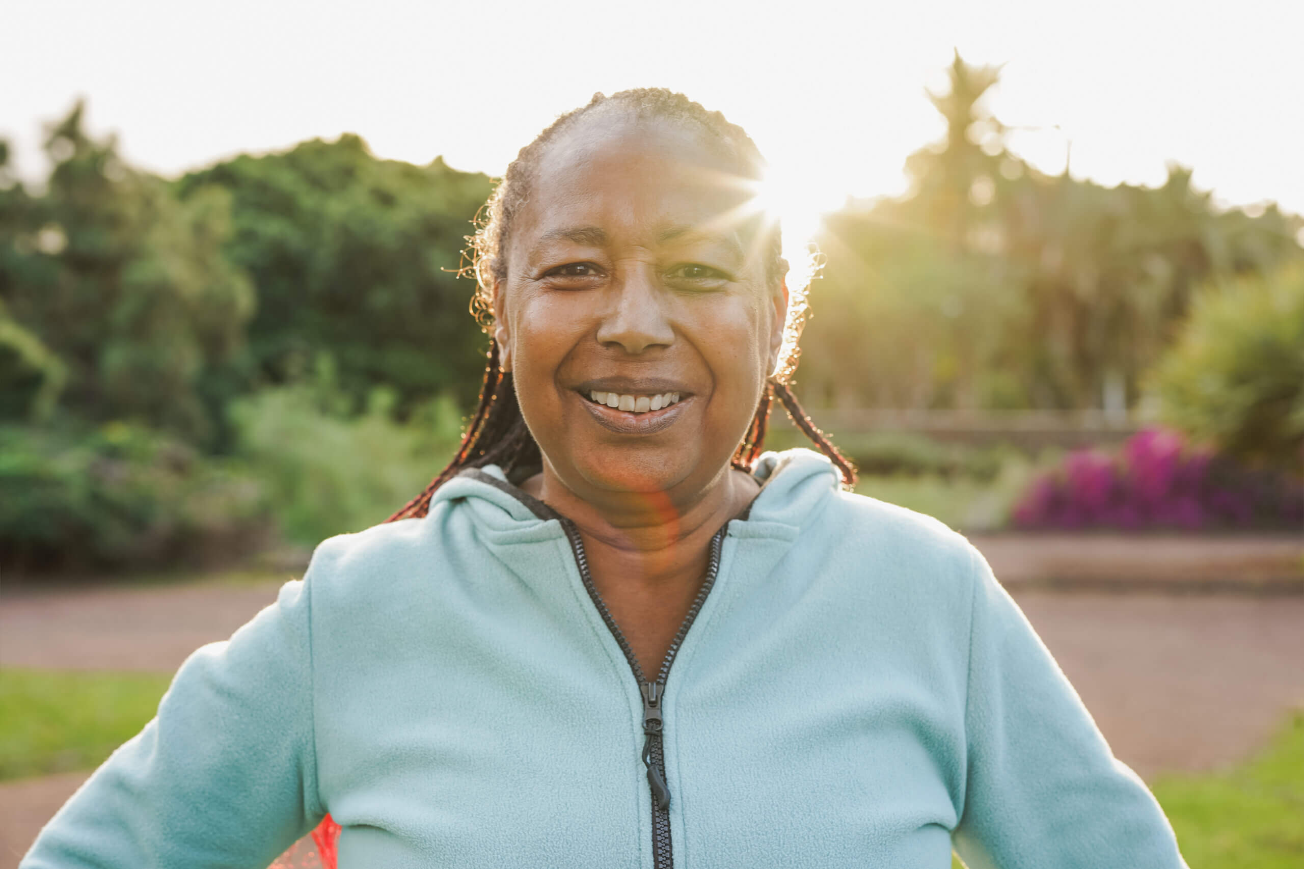 Anita smiling and standing in a green field.