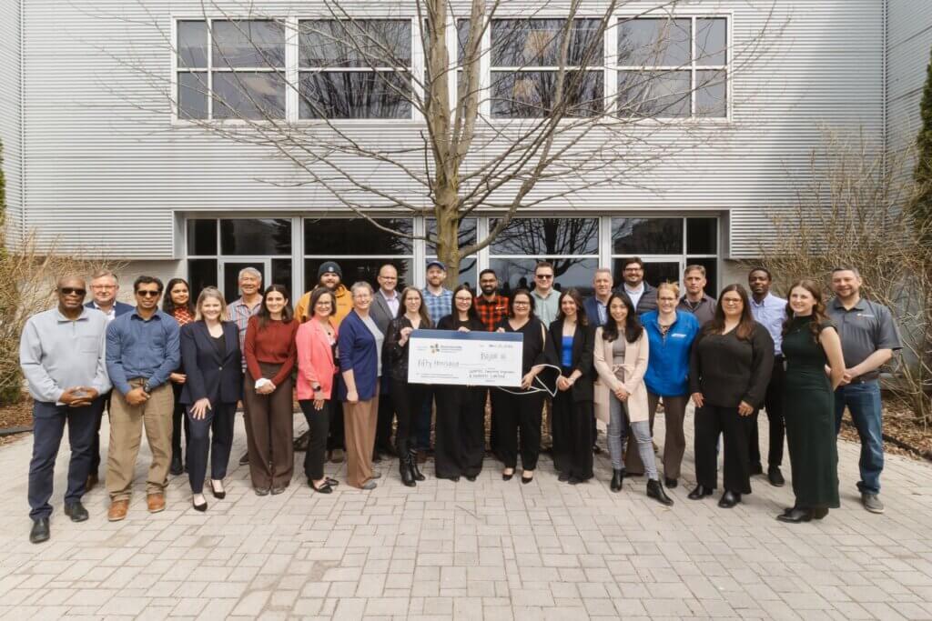 A large group of people gathered outside with an oversized cheque for $50,000 from GEMTEC to the Bowmanville Hospital Foundation.