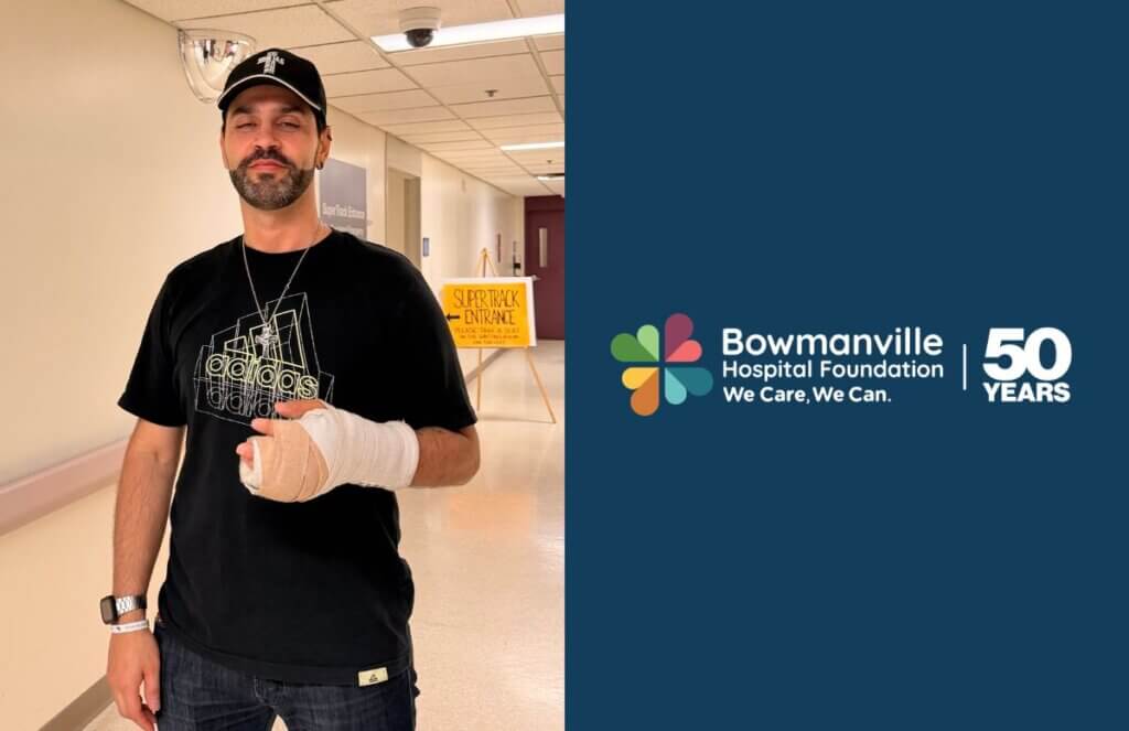 Chris standing with his arm in cast outside of the Emergency Department super track entrance at Bowmanville Hospital.