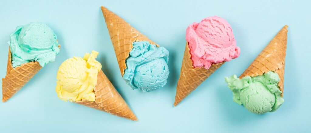 Colourful ice cream in waffle cones.
