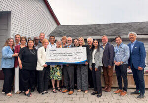 A large group of leaders standing outside holding an oversized cheque from the Municipality of Clarington for $3.75 million made out to the Bowmanville Hospital Foundation.