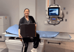 Jennifer, Charge Technologist, sitting on new X-ray unit at Bowmanville Hospital.